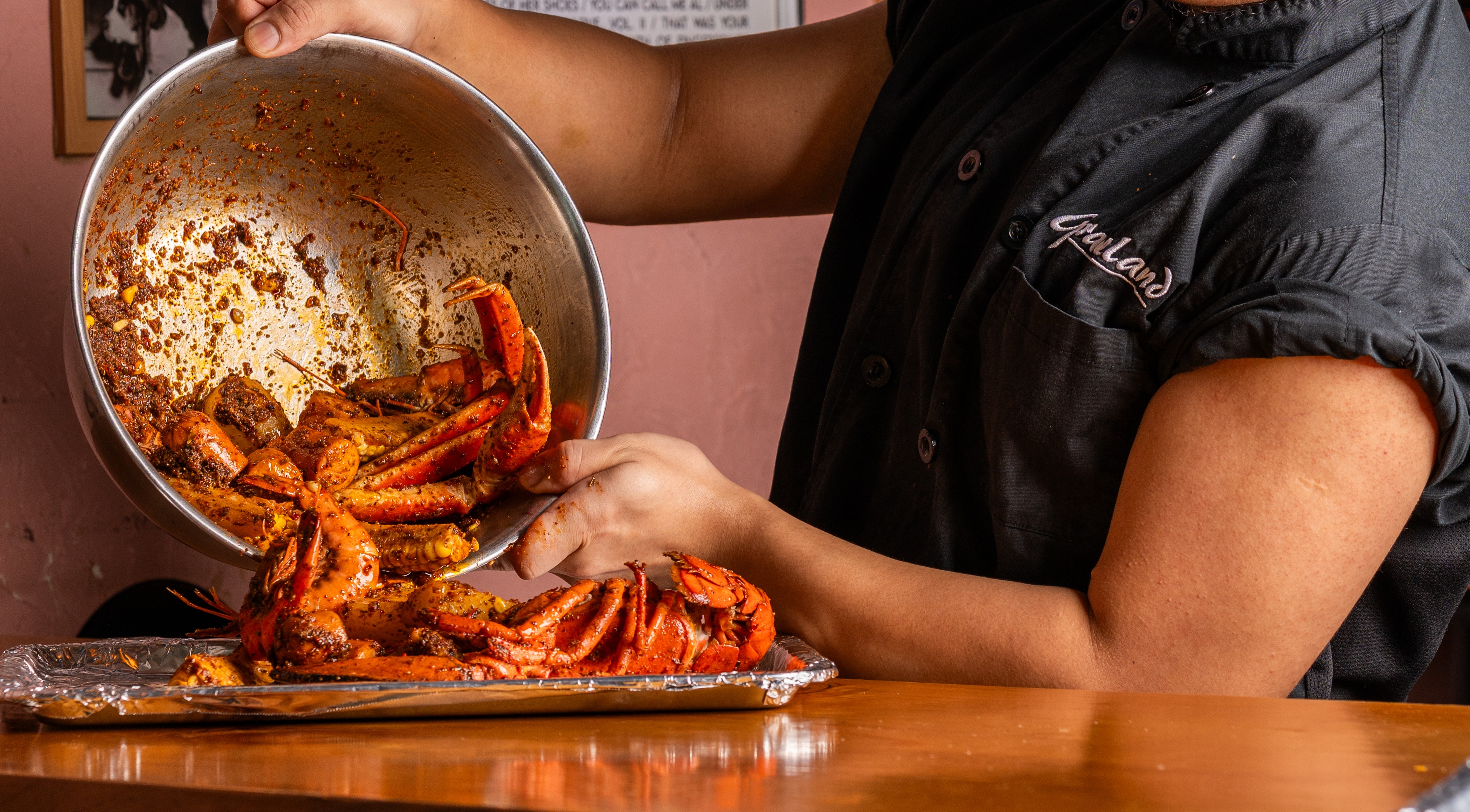 Chef preparing Graceland's legendary Cajun seafood boil in Hong Kong kitchen - American Southern cuisine